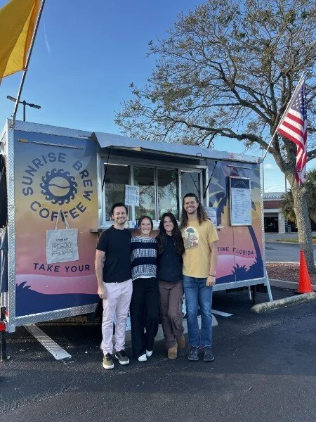 The Sunrise Brew team standing together in front of the coffee truck