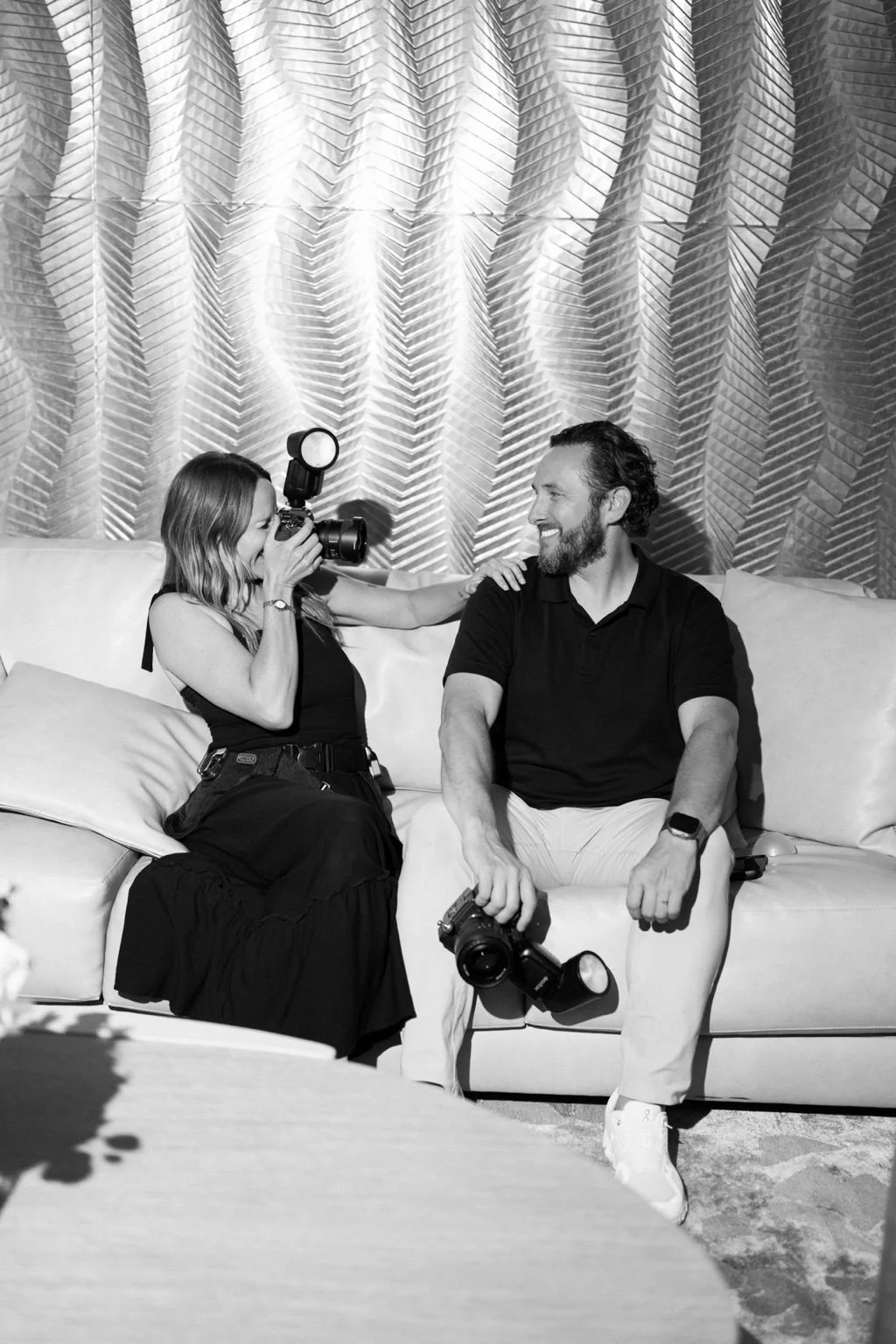 Jaclyn playfully photographing Andrew while seated together