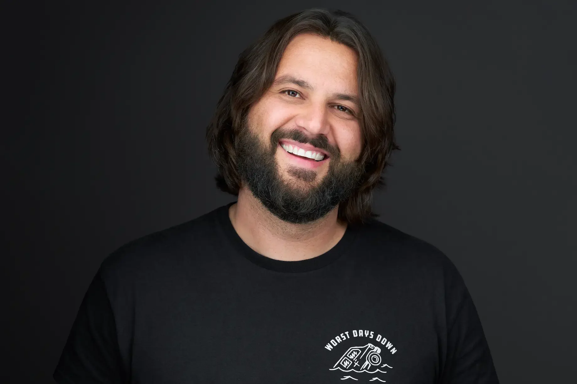 Professional headshot of Henry Sir, Edmonton comedian, on a charcoal backdrop at Maverick Studios