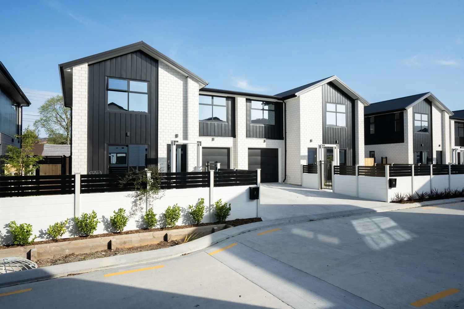 White brick facades, dark cladding and defined entrances at Oliver Place, Upper Hutt