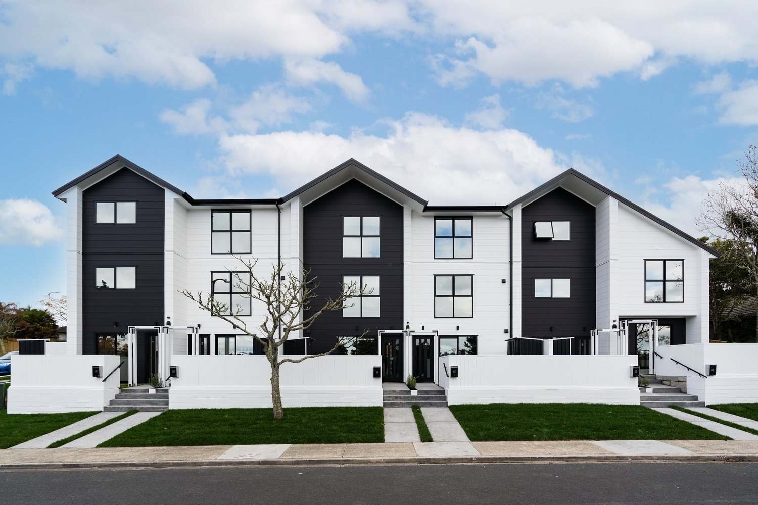 Black and white gabled townhouses with individual entrances at 2 Jadewynn Drive, Massey