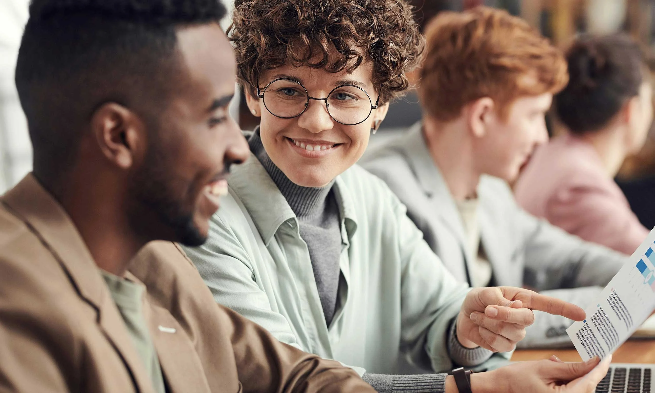 Small team working together efficiently to serve multiple customers in a busy shop or office. Smiling, confident, and organized team dynamic.”