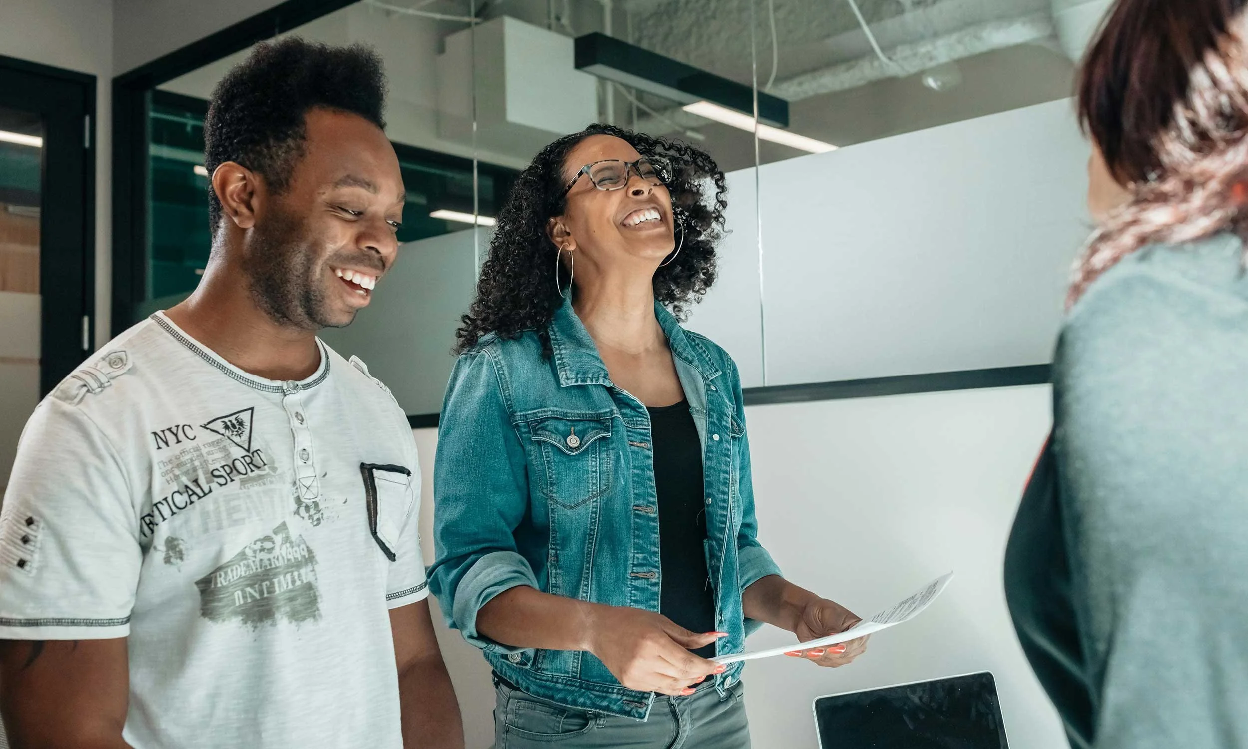 Small business owner talking happily with customers at a boutique, stall, or service desk. Friendly engagement, vibrant atmosphere, showing effective marketing results.