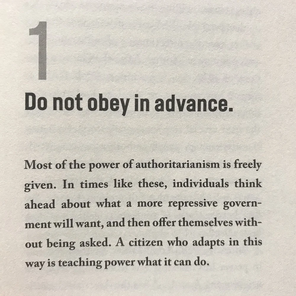 Protesters standing together with anti-authoritarian messages