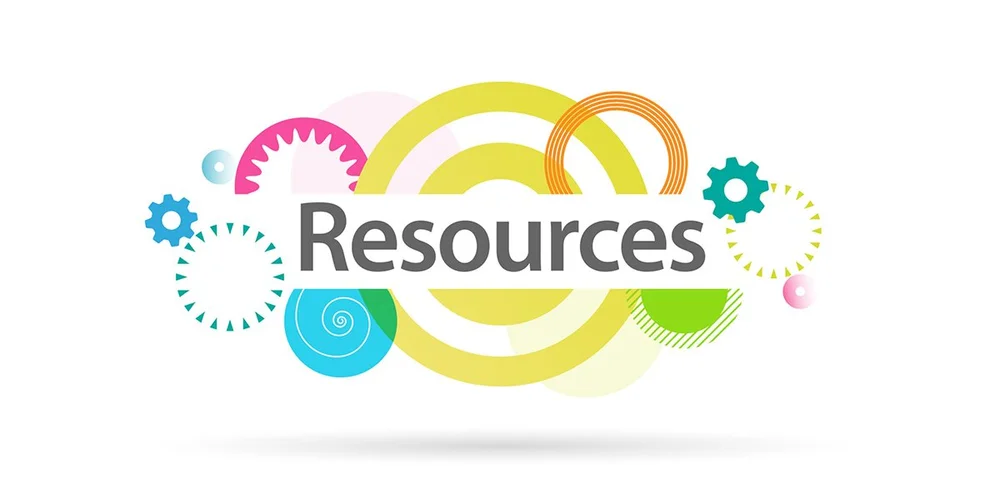 Books, guides, and resources stacked on a desk