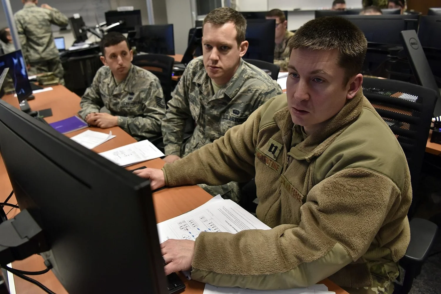 U.S. Air Force cyber Airmen work at computer workstations during a defensive cyber operations training exercise