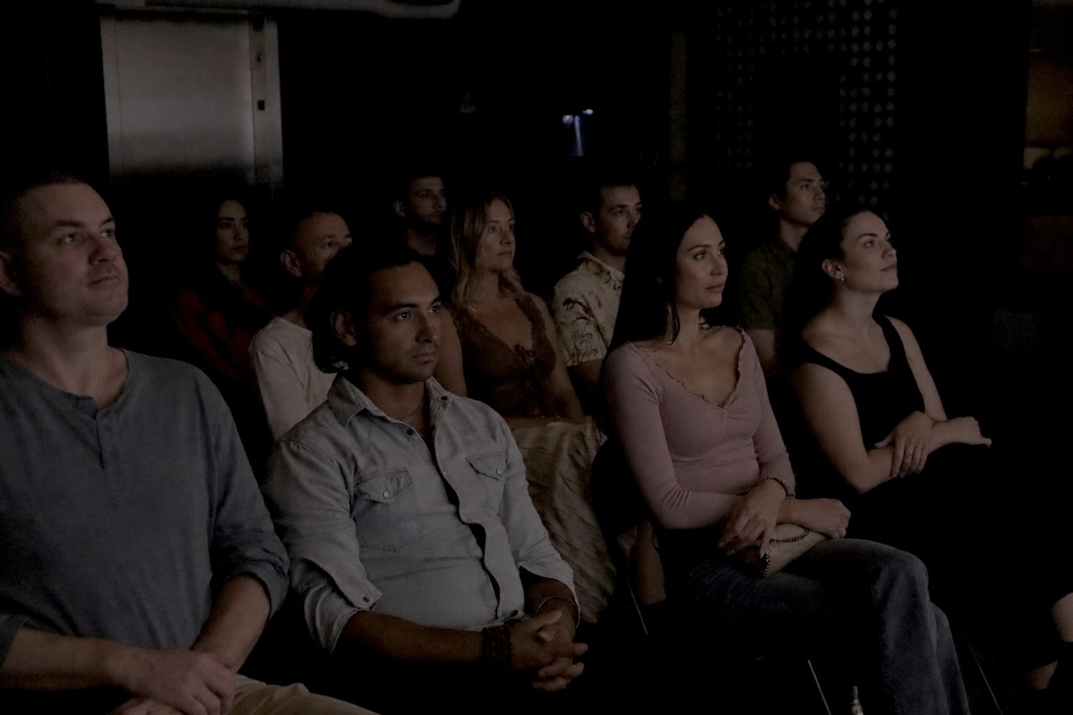 Engaged audience watching a live public-speaking event at Kama