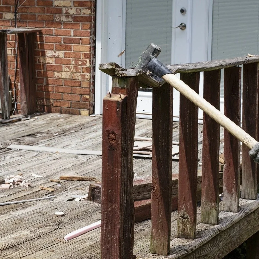 spongy gray deck boards near rusted joist hangers