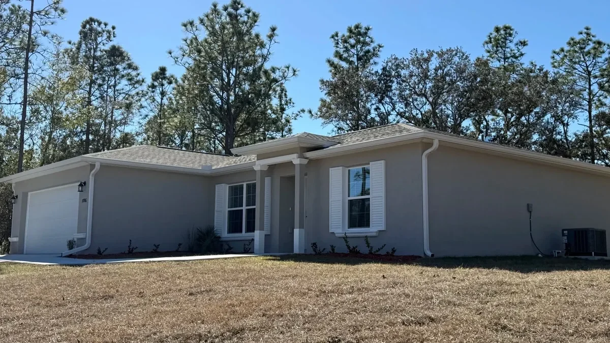 White seamless gutters installed on a stucco home in Citrus Springs, Florida.