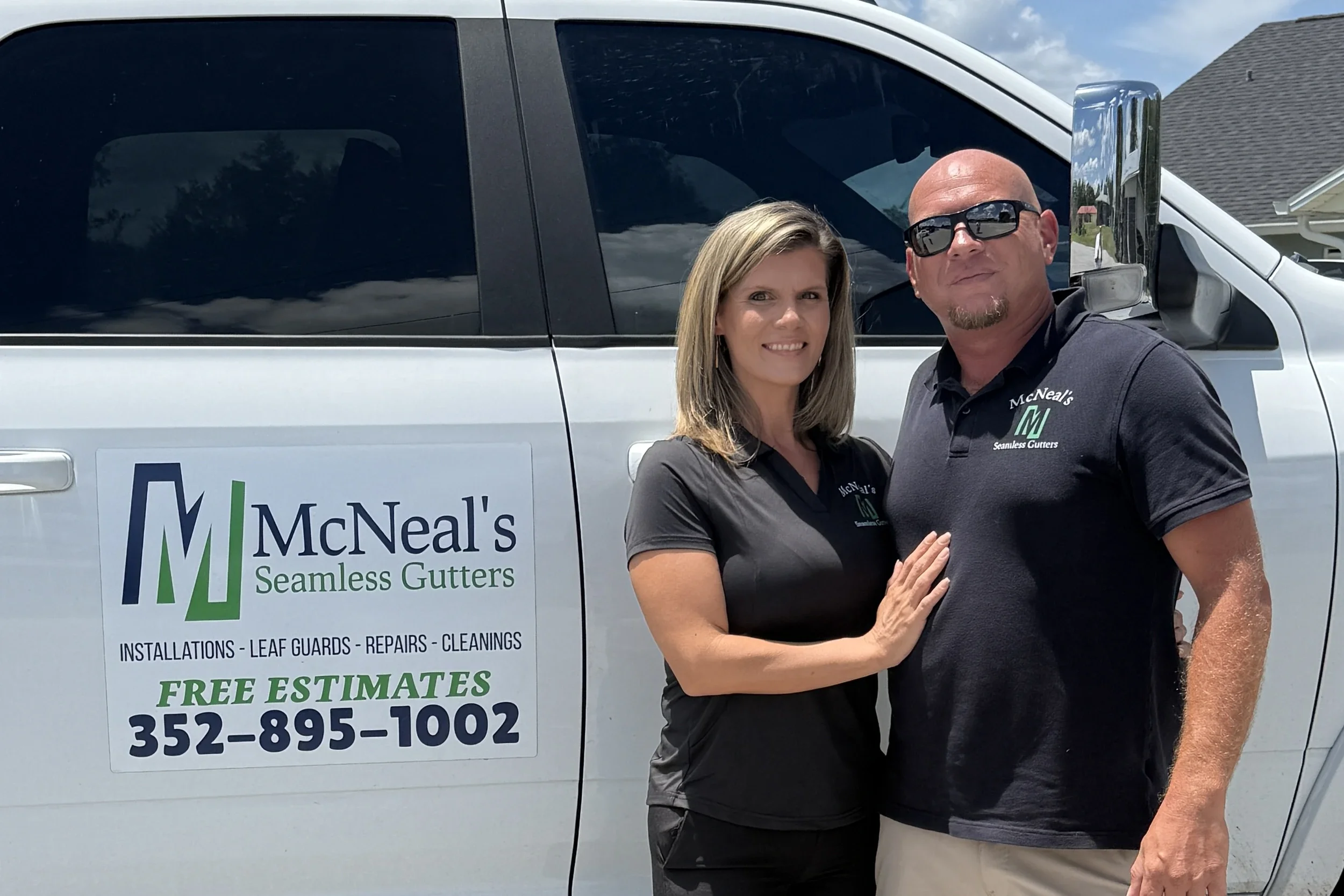 Danny and Danielle McNeal beside their McNeal’s Seamless Gutters truck