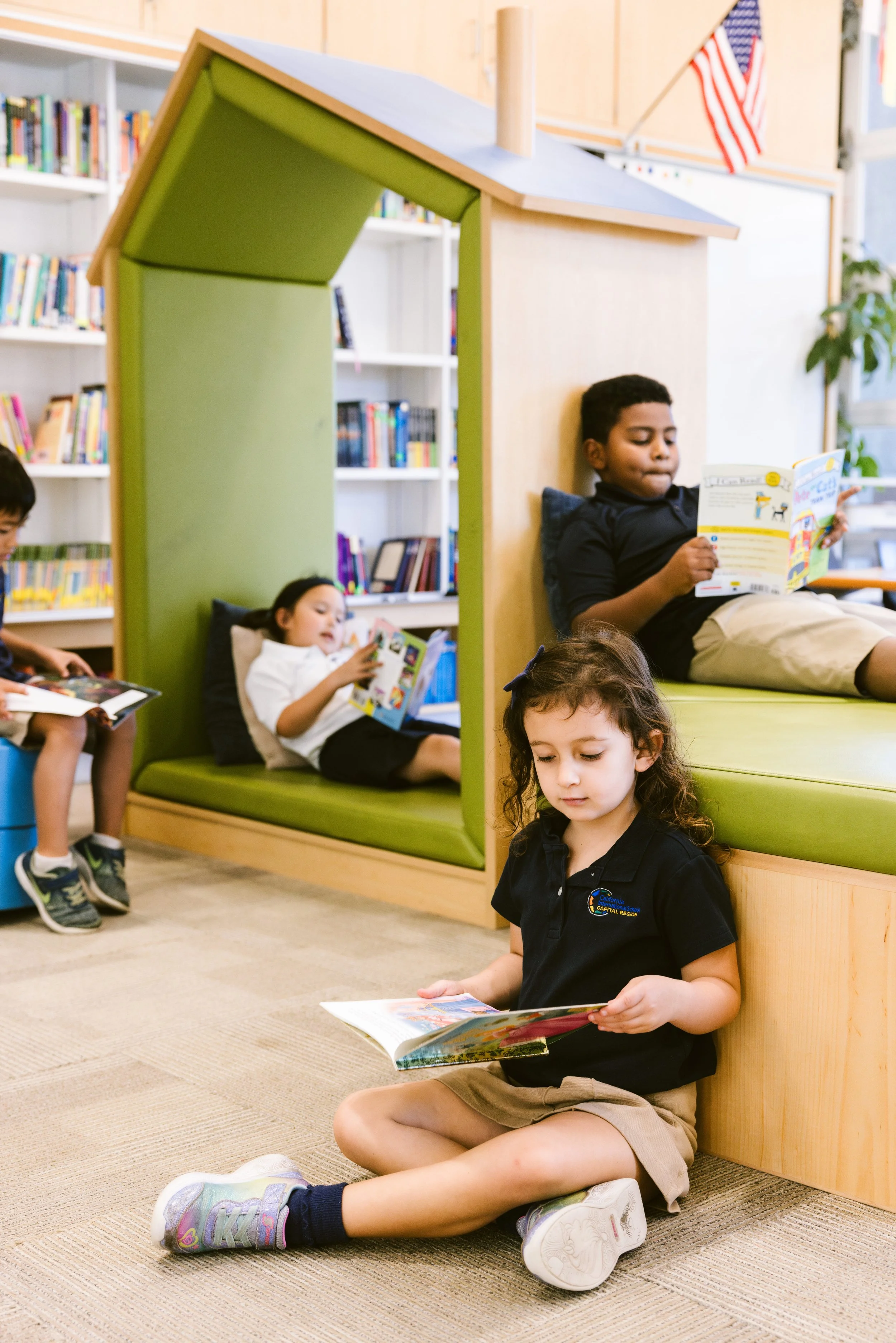 Students engaged in independent reading and learning in modern library space