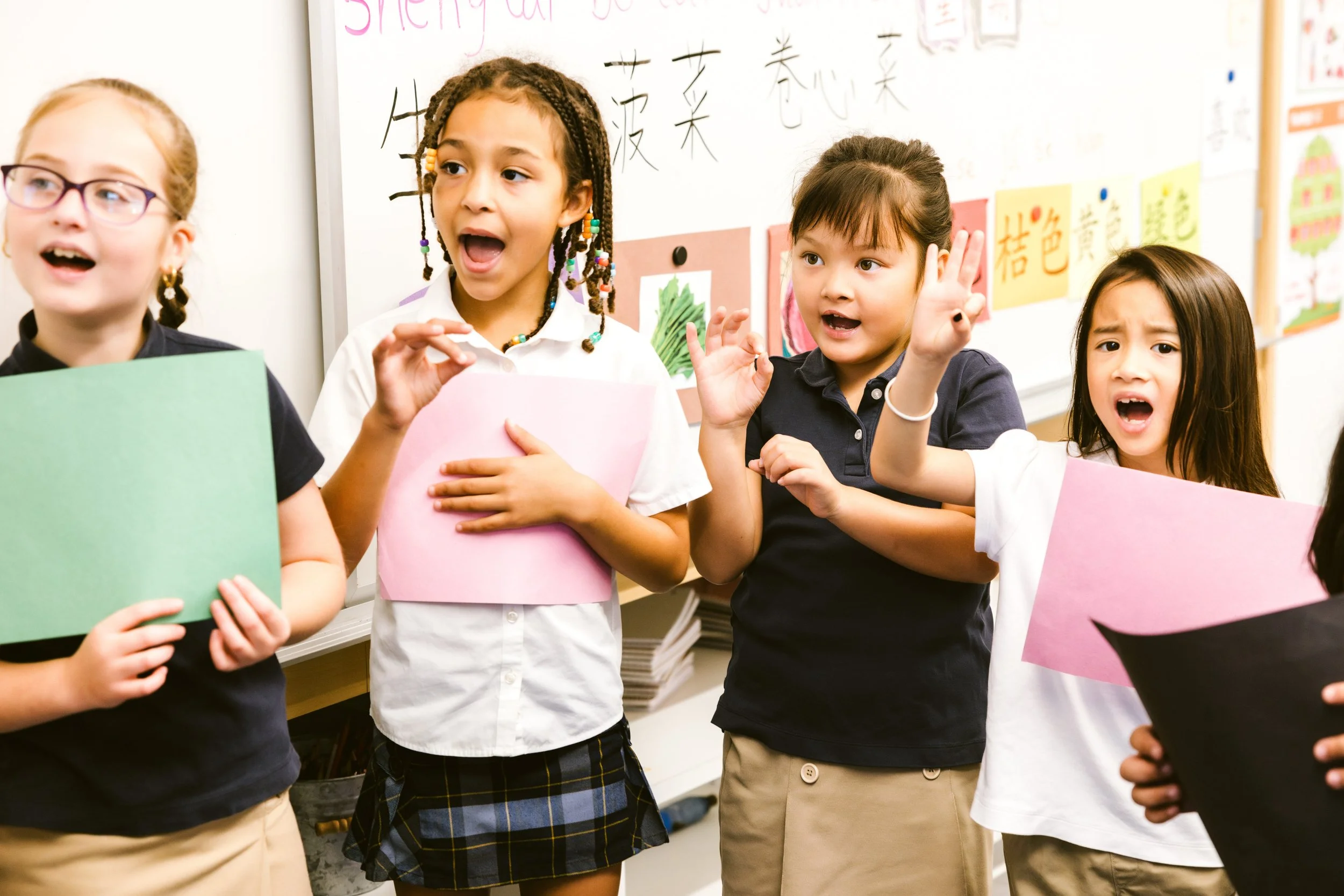 Students enthusiastically participating in classroom activity with colorful materials