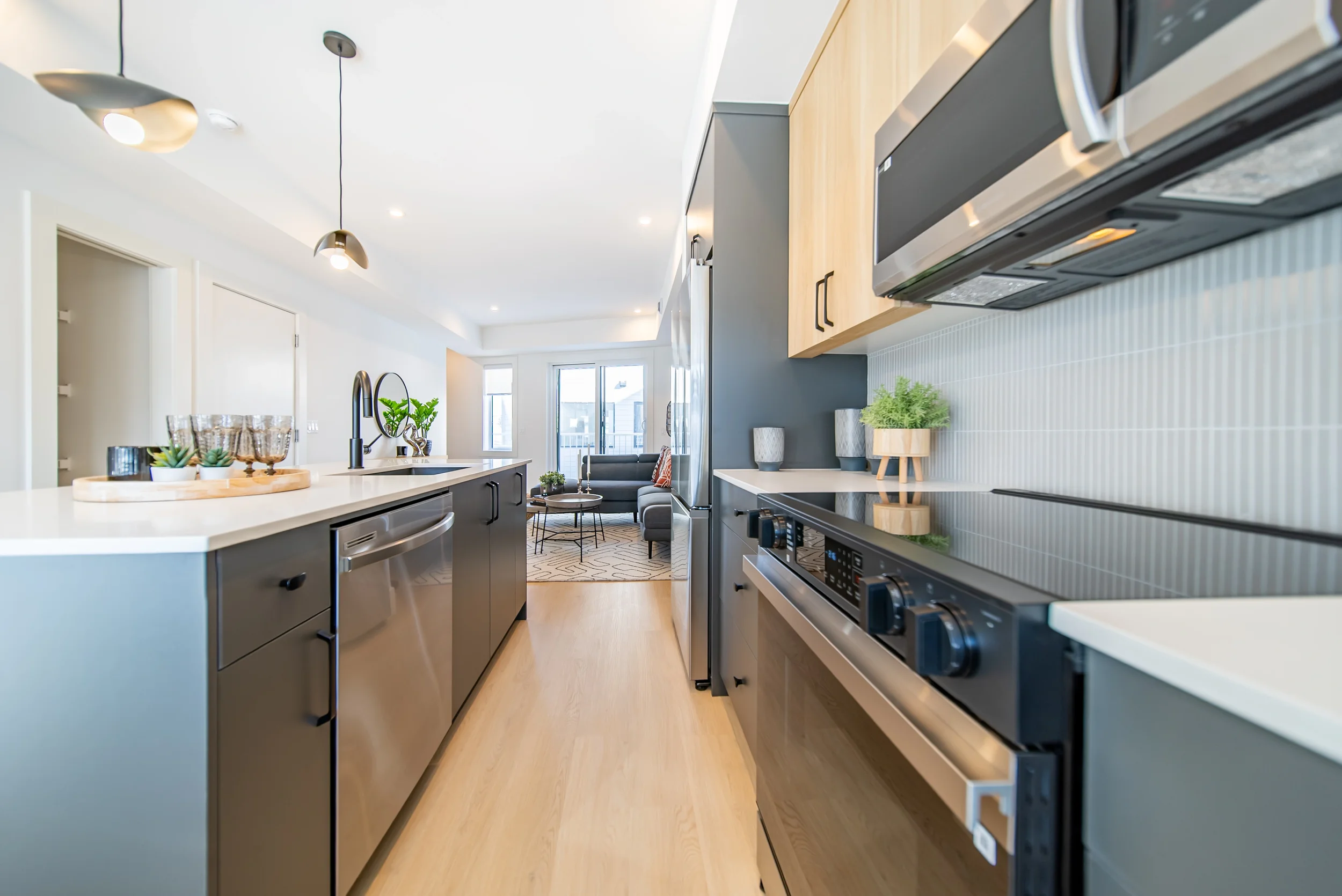 Kitchen and dining area in townhomes for rent in Calgary featuring sleek cabinetry and bright natural light