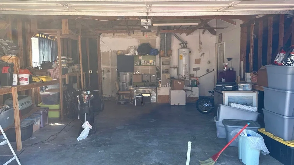 Garage after unwanted items were removed with open floor space in the center