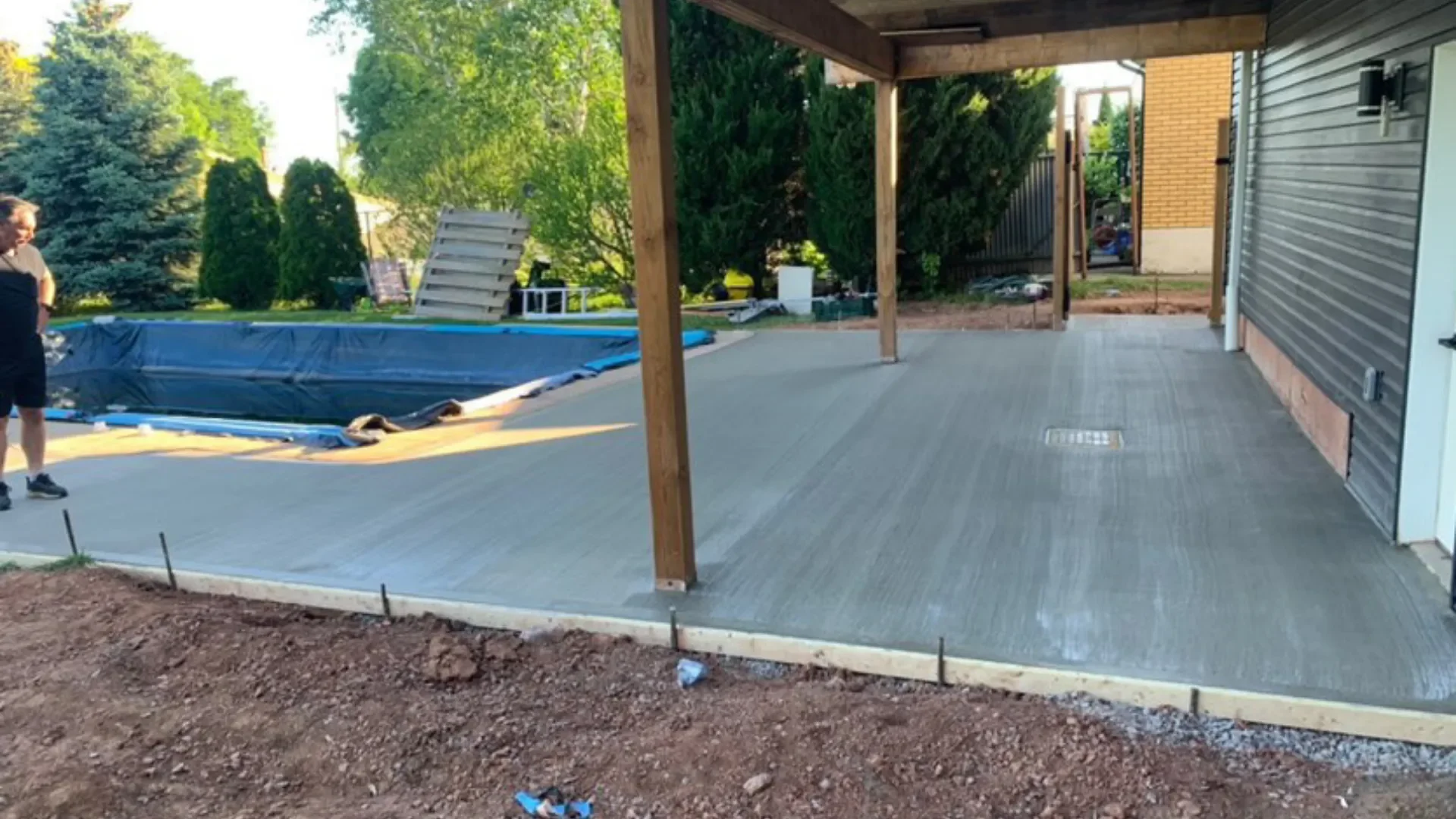 Fresh broom-finish concrete pool deck and patio pour in St. Catharines