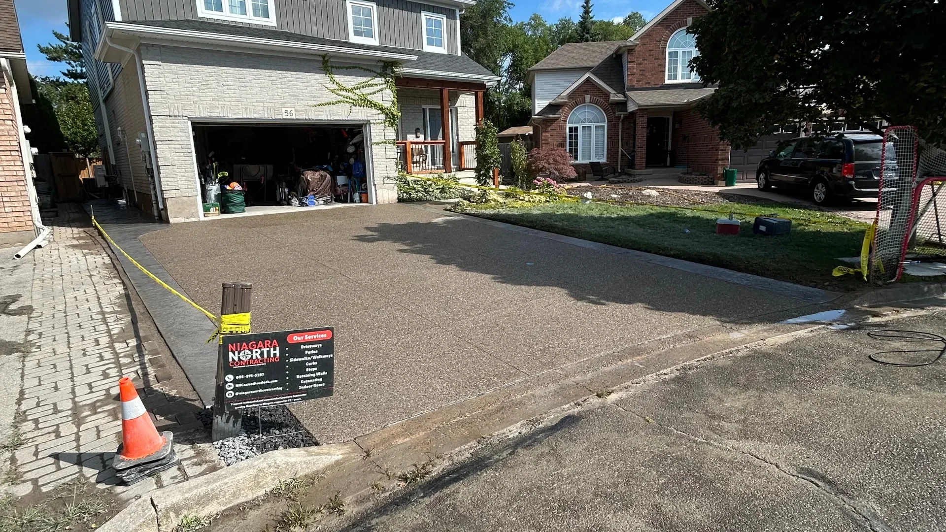 Exposed aggregate concrete driveway with stamped slate border by Niagara North Contracting in Lincoln