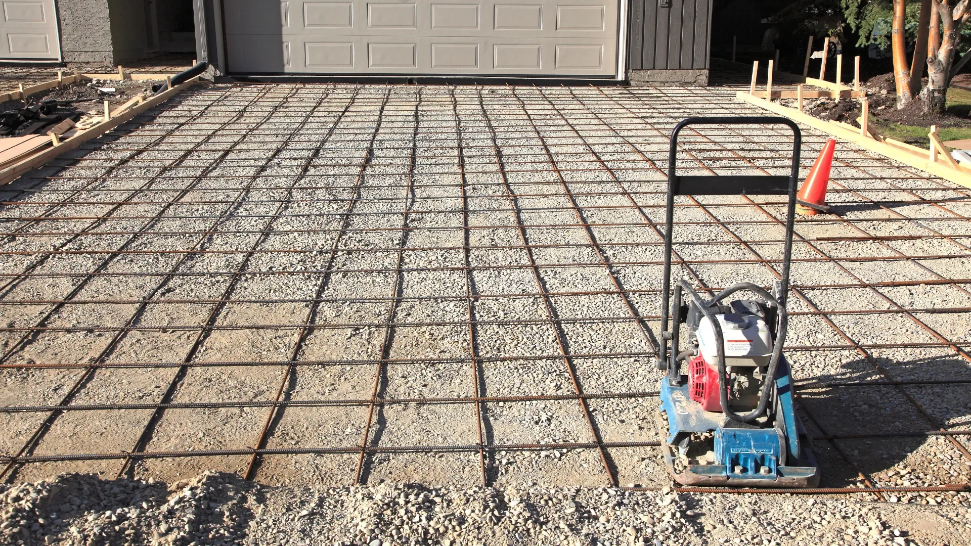 gravel base and rebar prepared for a concrete driveway pour
