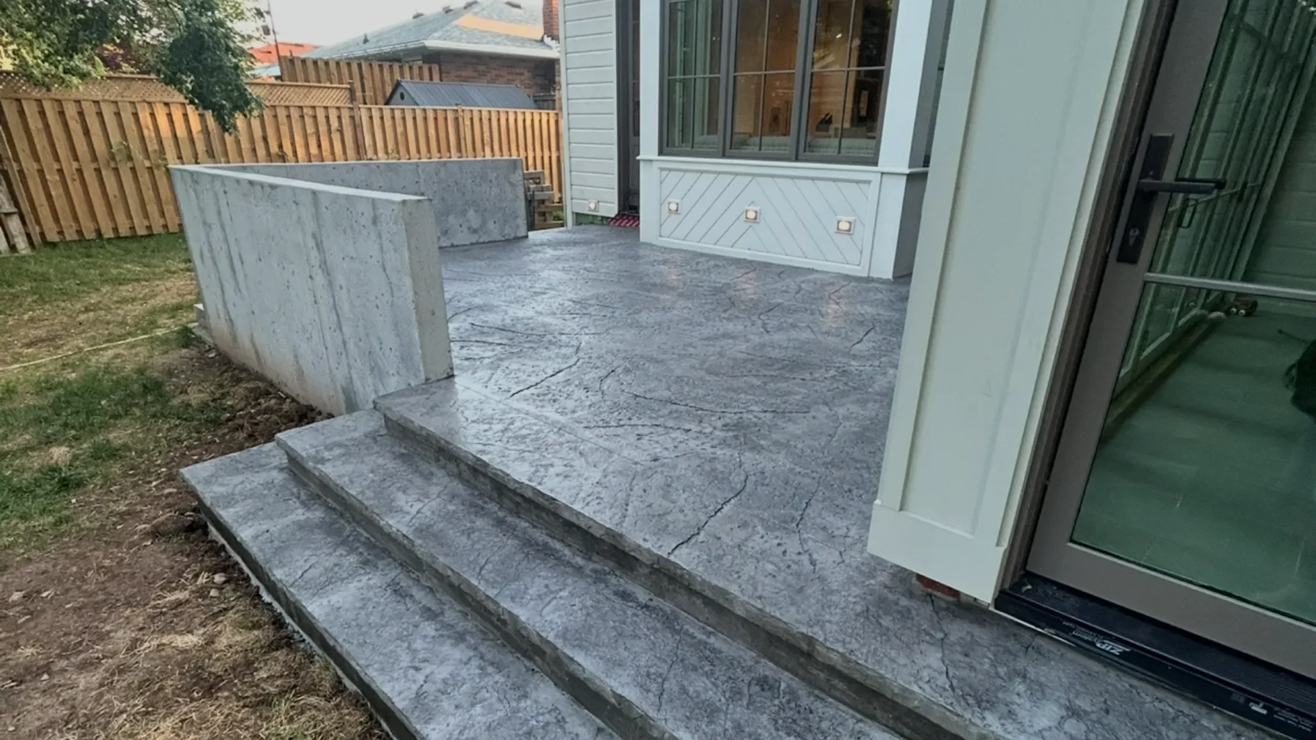Stamped concrete patio with steps and retaining wall in Grimsby