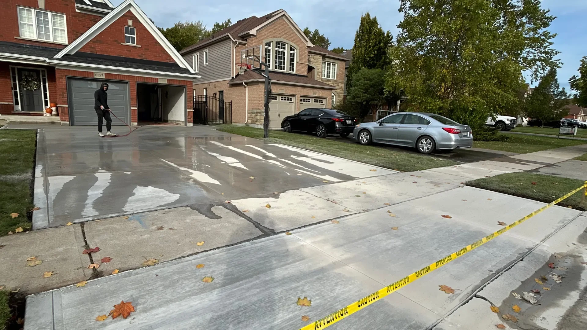 Residential concrete driveway being cleaned with a pressure washer in St. Catharines