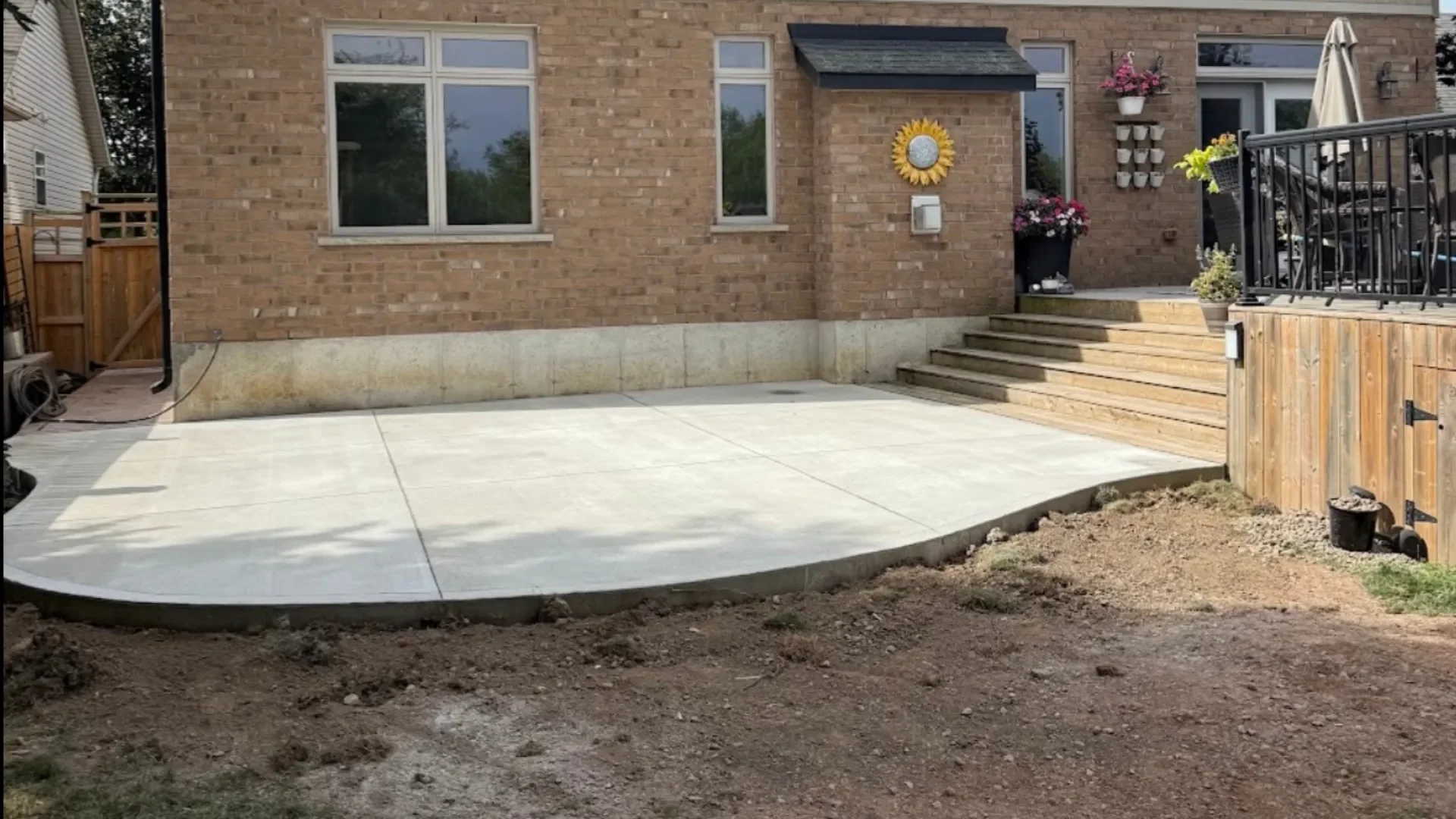 Broom-finish concrete patio with curved edge in a Grimsby backyard