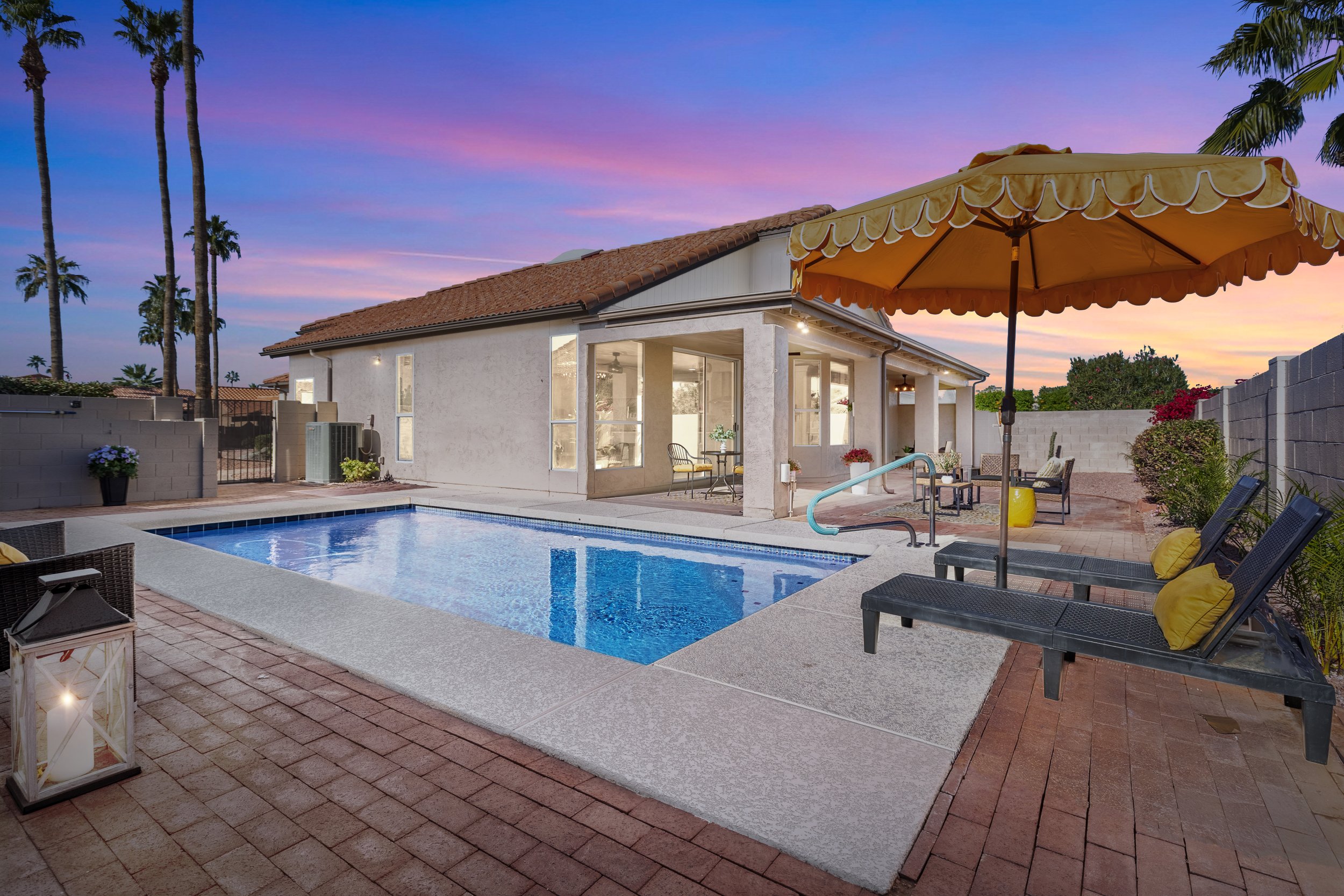 Twilight photo of a rental property pool or patio feature