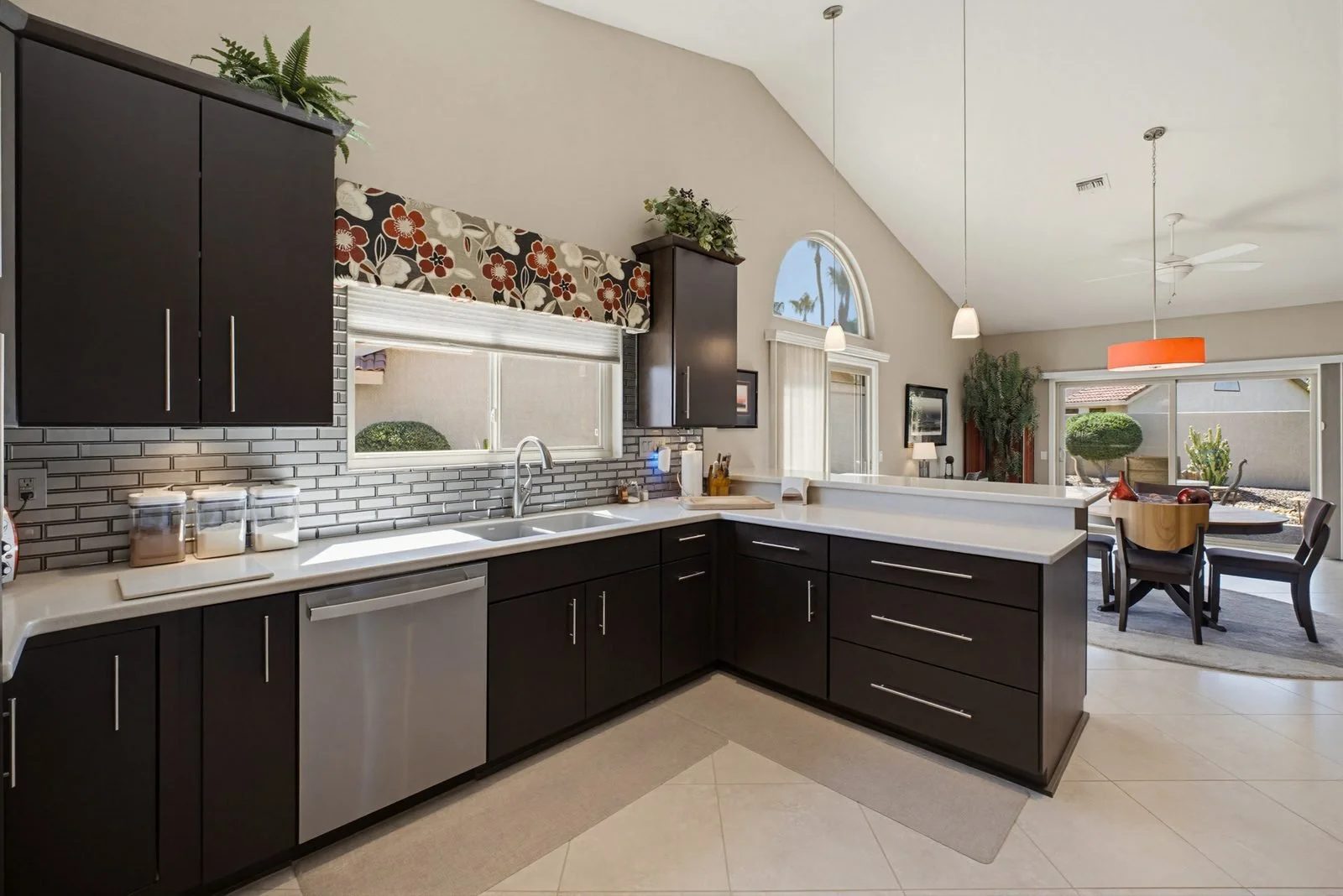 Kitchen with dark cabinetry and tile backsplash in a Peoria home