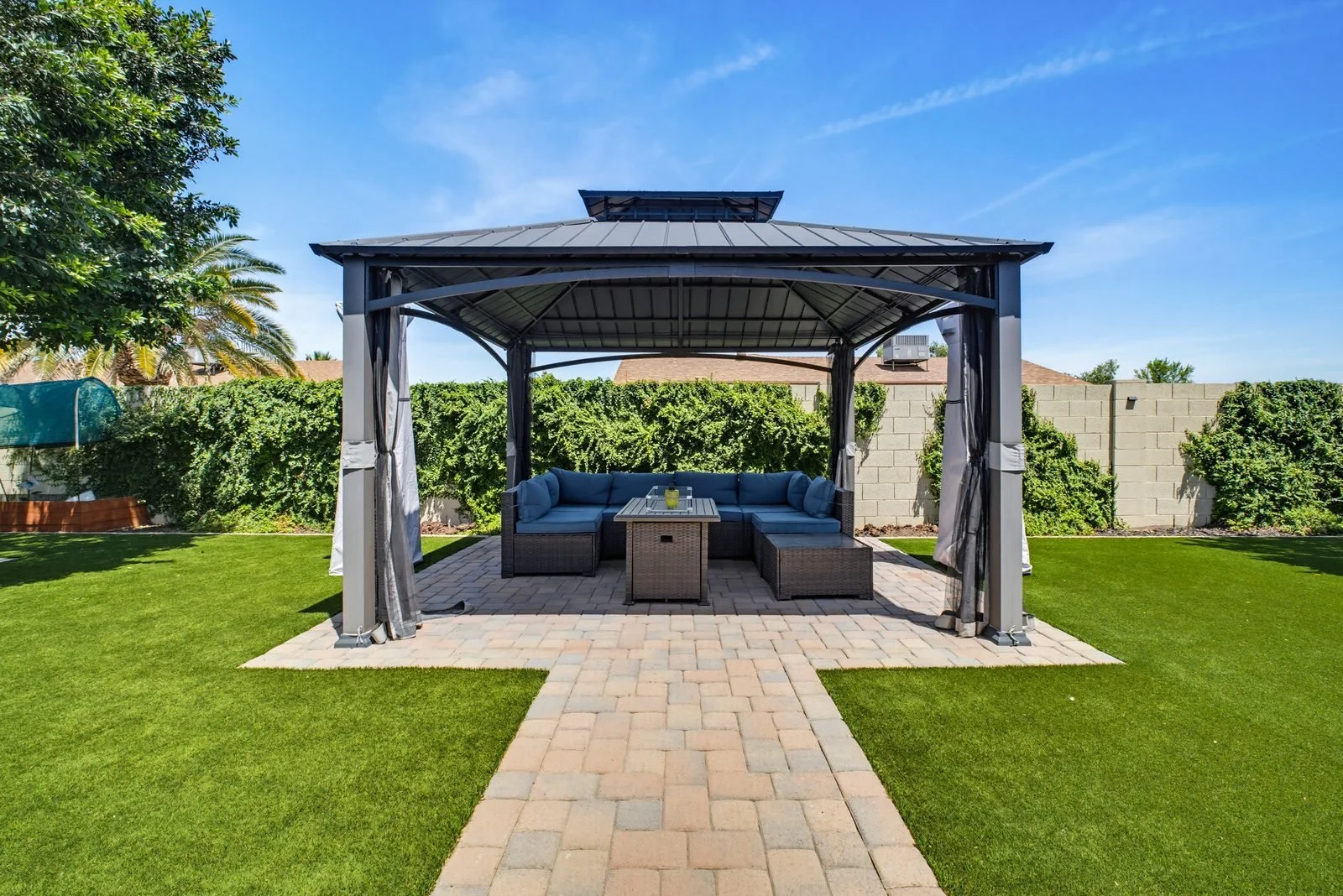 Backyard gazebo with seating area and artificial turf in a Peoria home