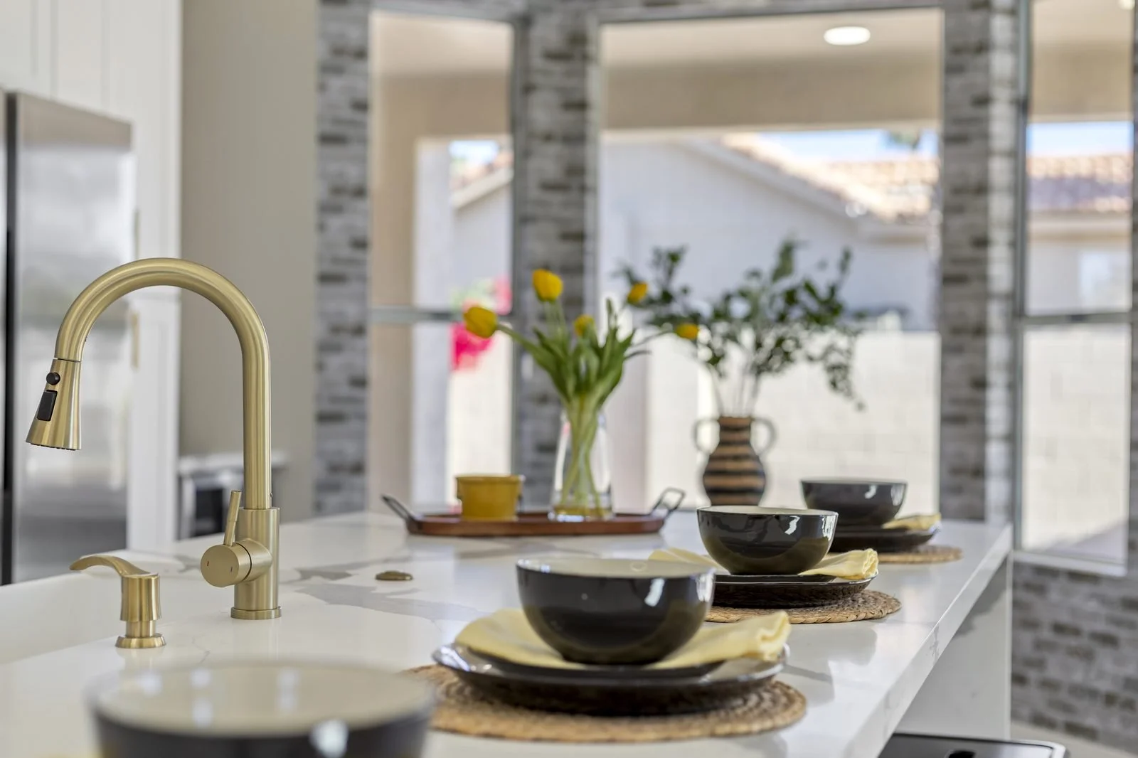 Kitchen island detail with brass faucet in a Glendale home