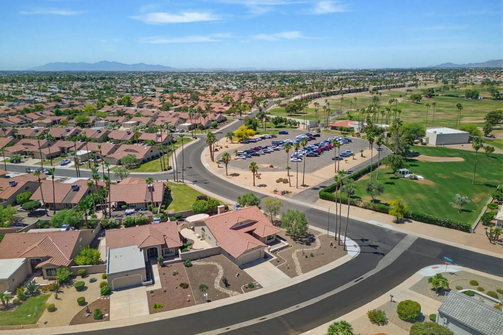 Aerial view of a Peoria, AZ master-planned community with red-tile rooftops and golf course, photographed by Valley View Photo