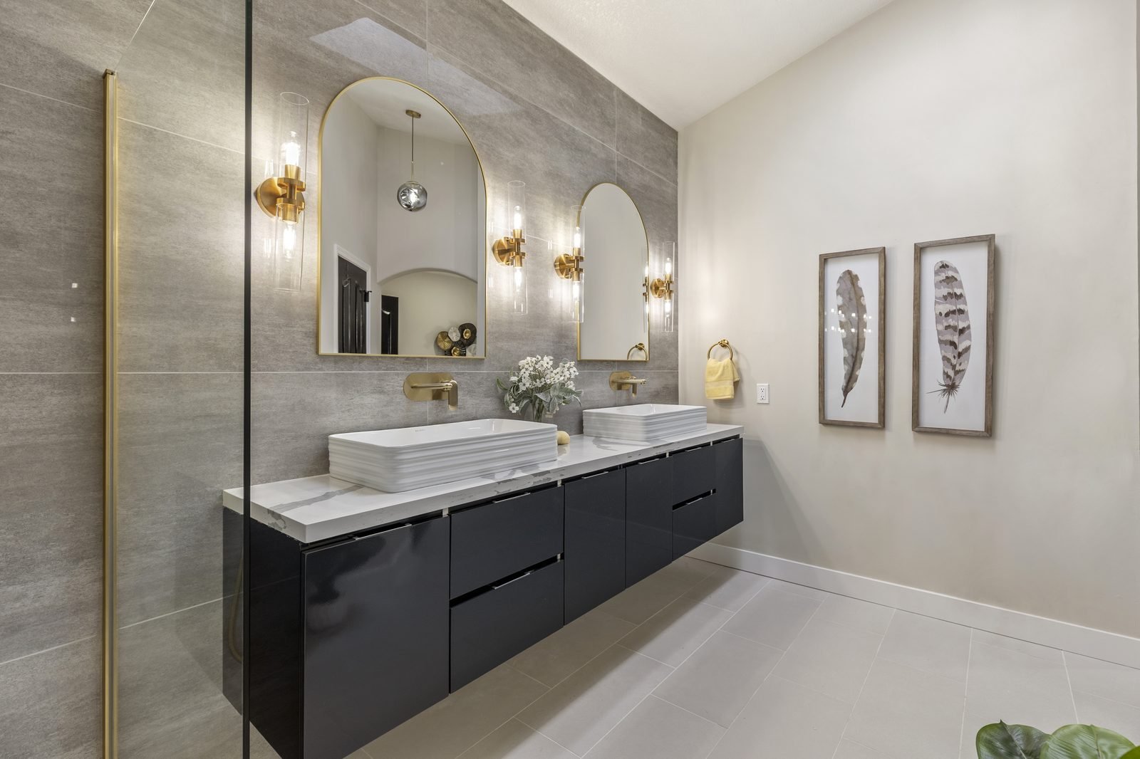 Modern bathroom with dual vessel sinks and gold fixtures in a Glendale home