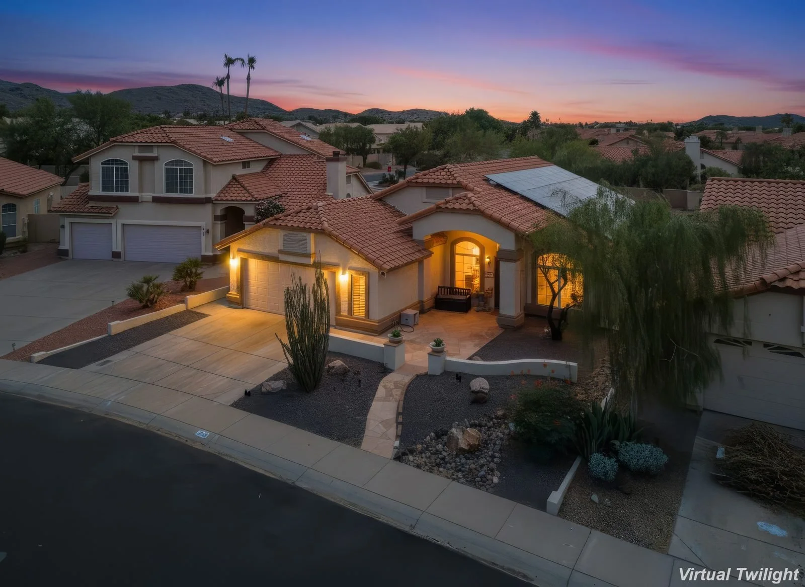 Twilight aerial photo of a Scottsdale home with mountain backdrop, captured by Valley View Photo