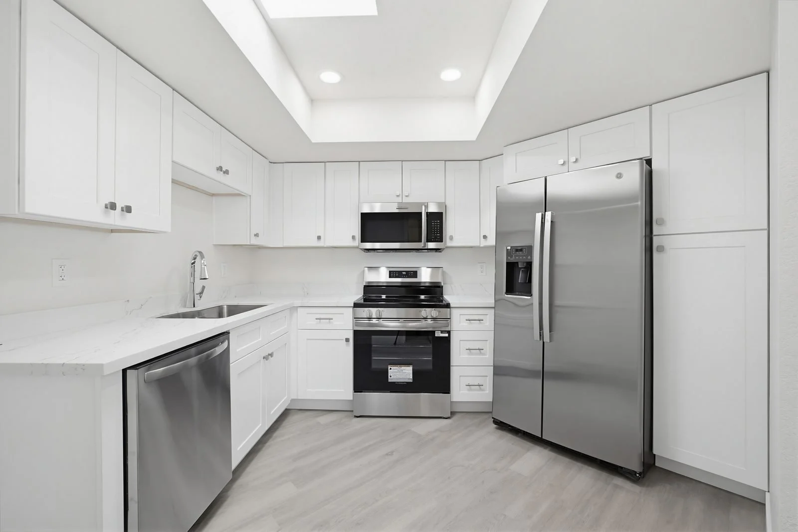 Updated white kitchen with stainless appliances in a Peoria home