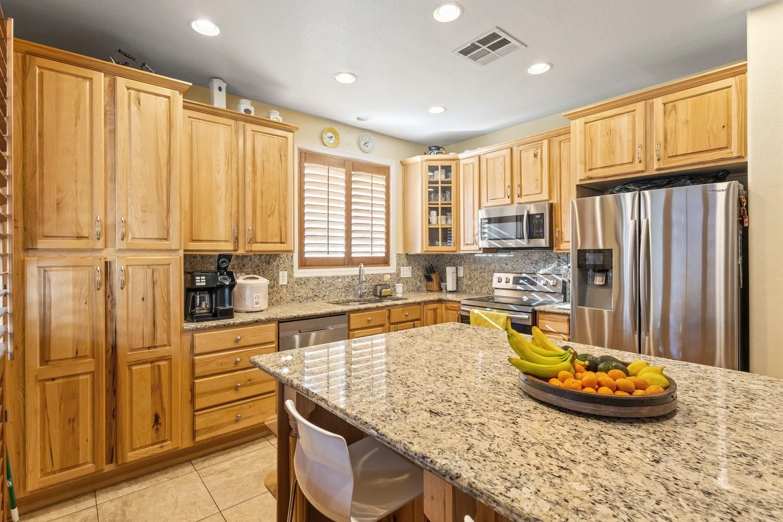 Kitchen with granite countertops and wood cabinetry in a Mesa home