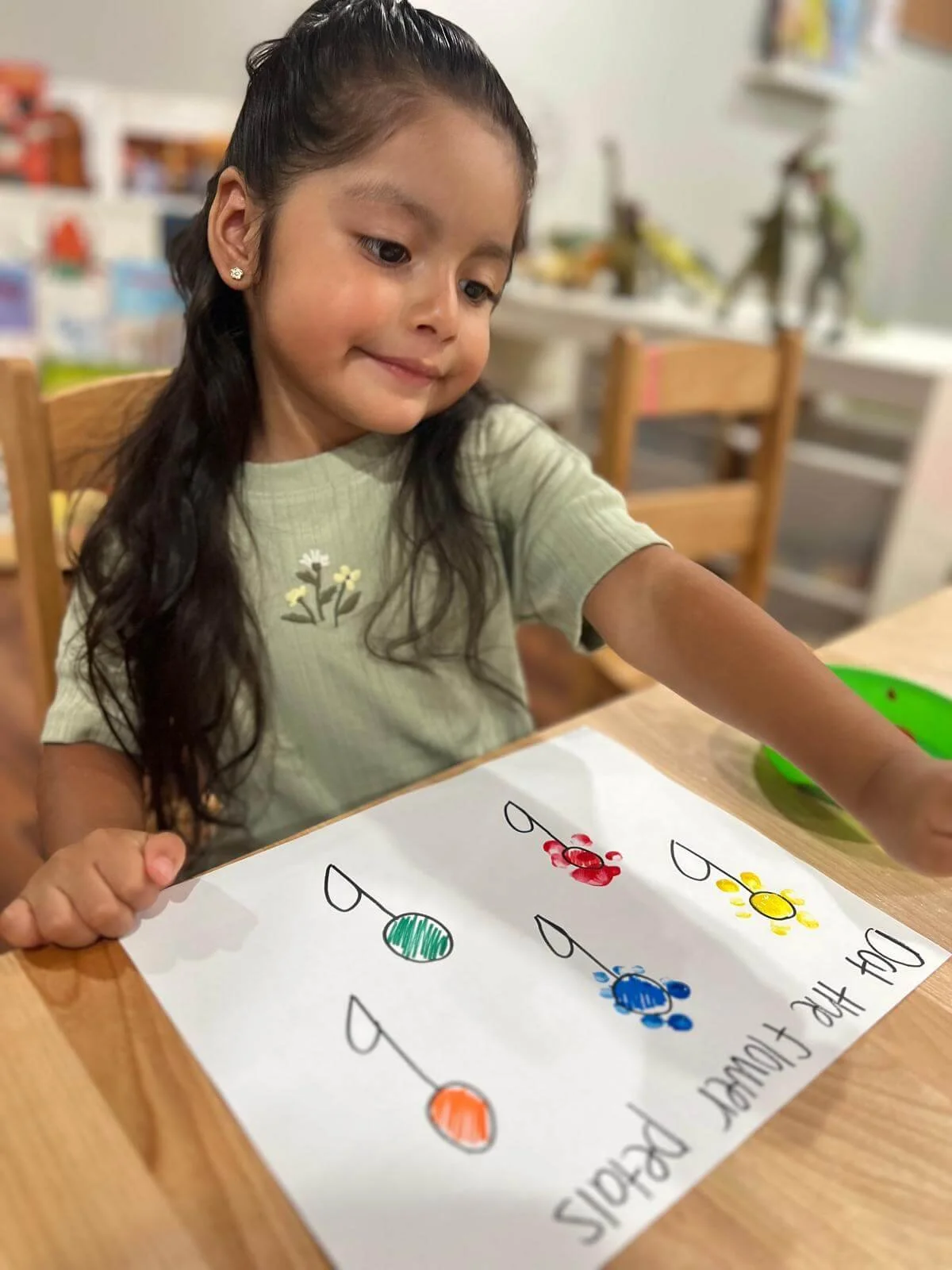 A preschooler learning with a worksheet at Gardens Day Care
