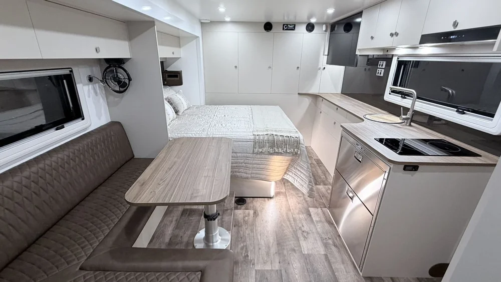 Wide view of the ibeX living area showing island bed, dinette and kitchen