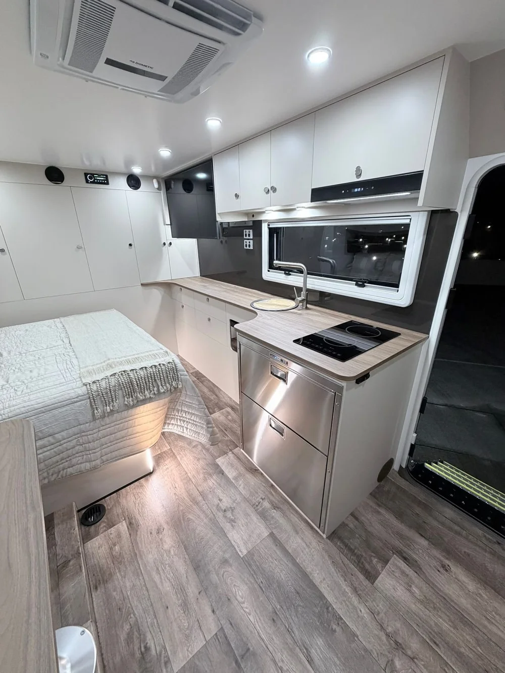Kitchen with induction cooktop, Laminex benchtop and stainless steel drawer fridge