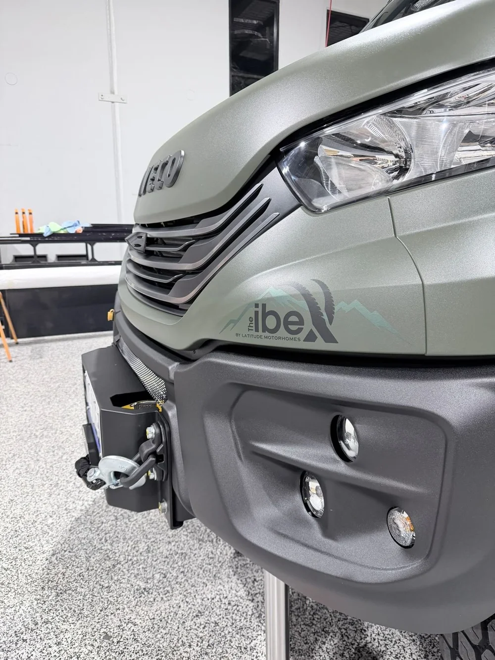 Close-up of The ibeX by Latitude Motorhomes badge on the front panel