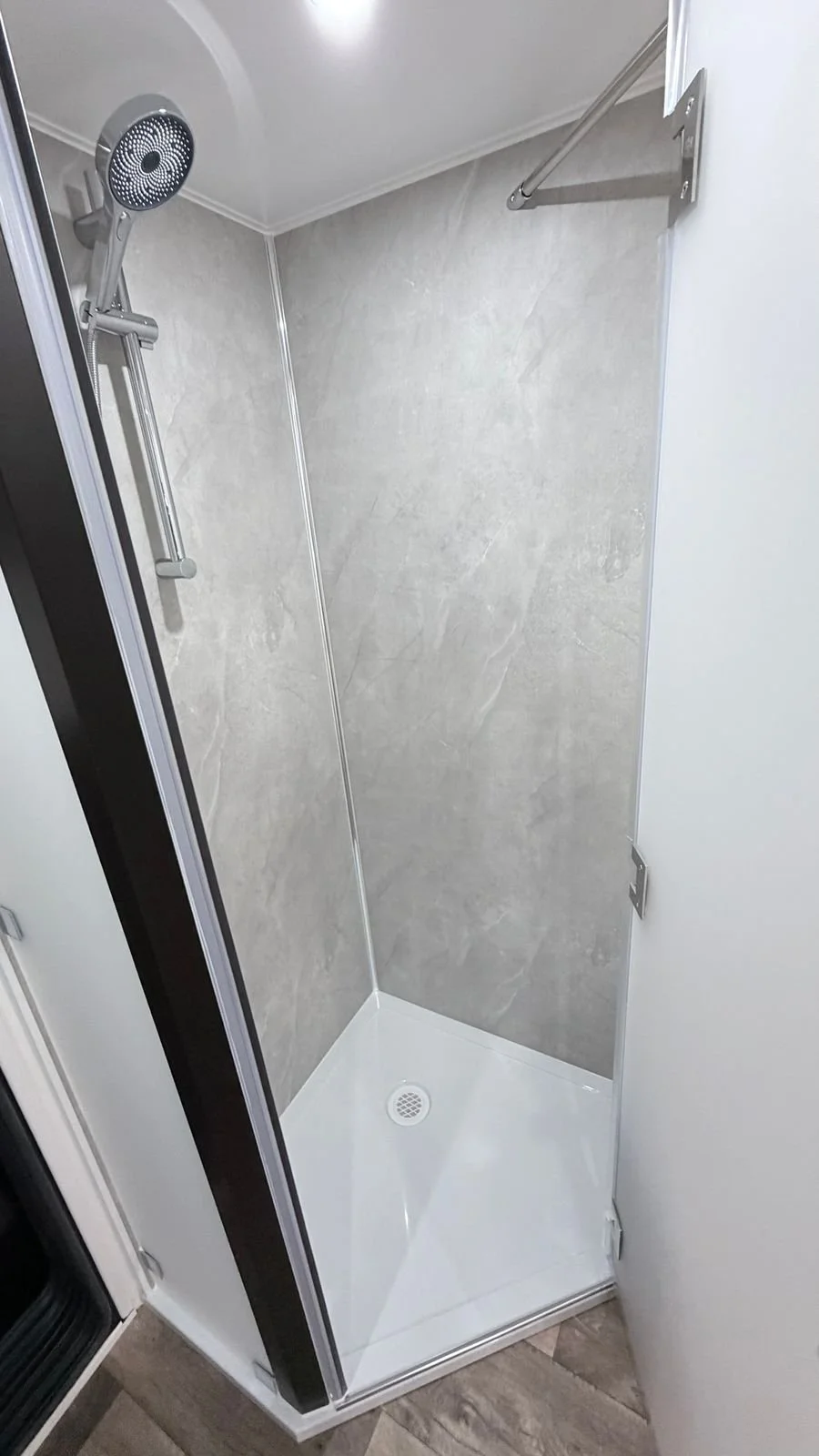 Ensuite shower with glass door and tiled walls
