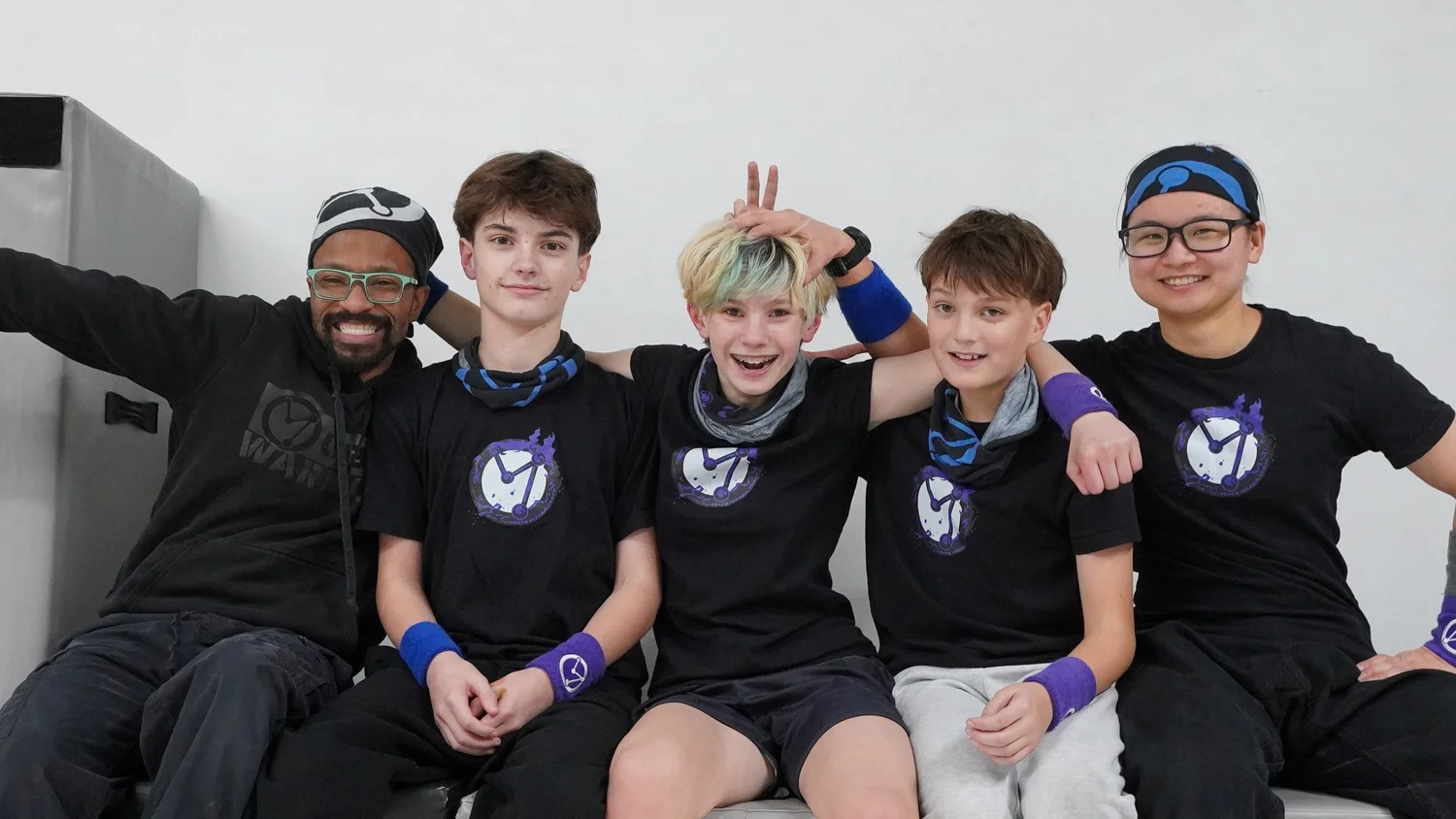 Five members of the Urban Warriors community smiling together in the gym