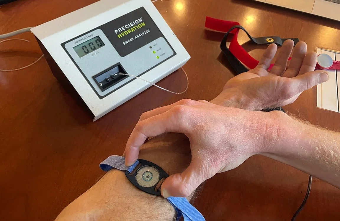 Sweat test equipment collecting sweat from a sensor on the arm