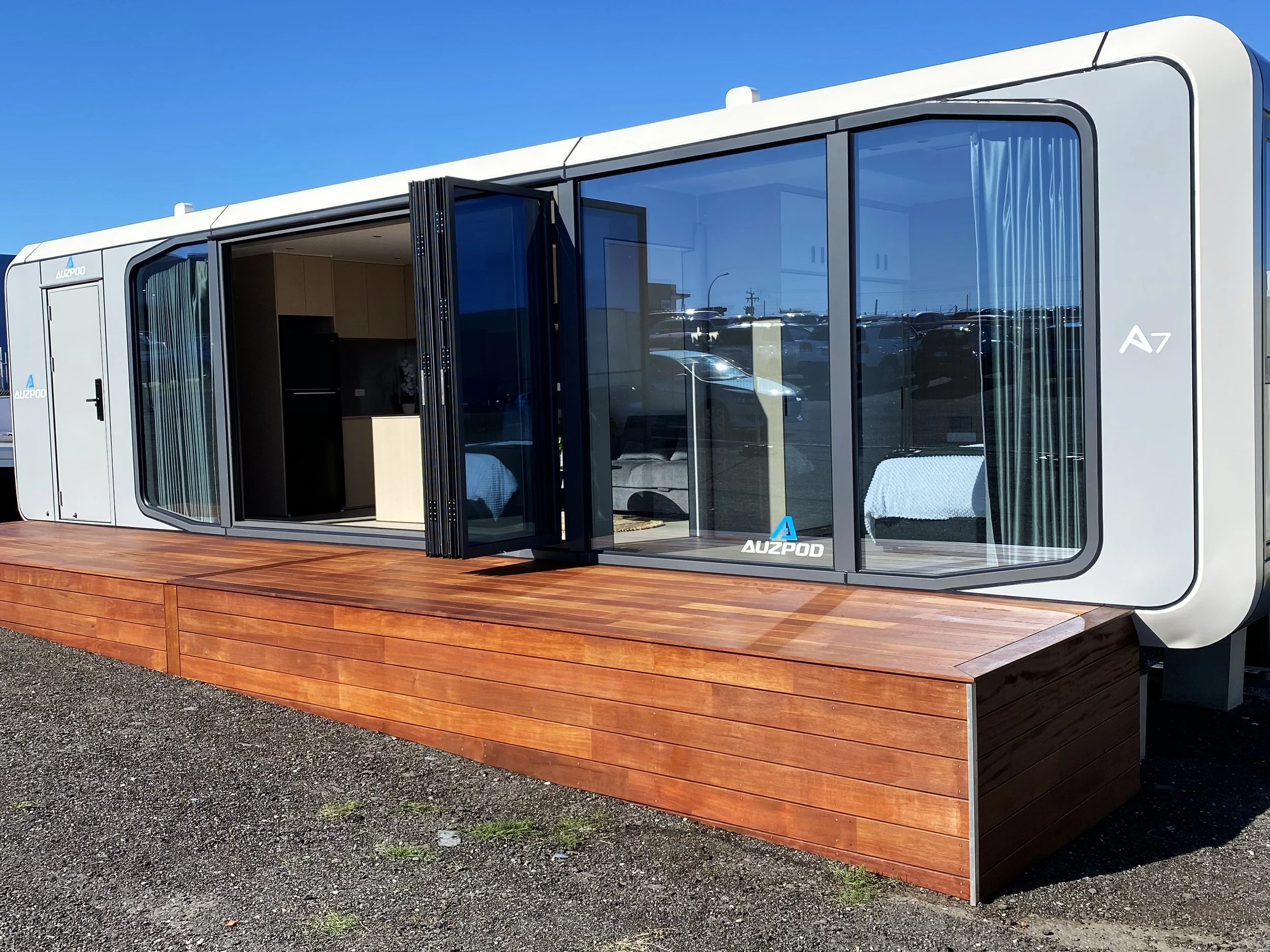 Installed AUZPOD with sliding doors open showing the interior living space on a prepared site in Western Australia