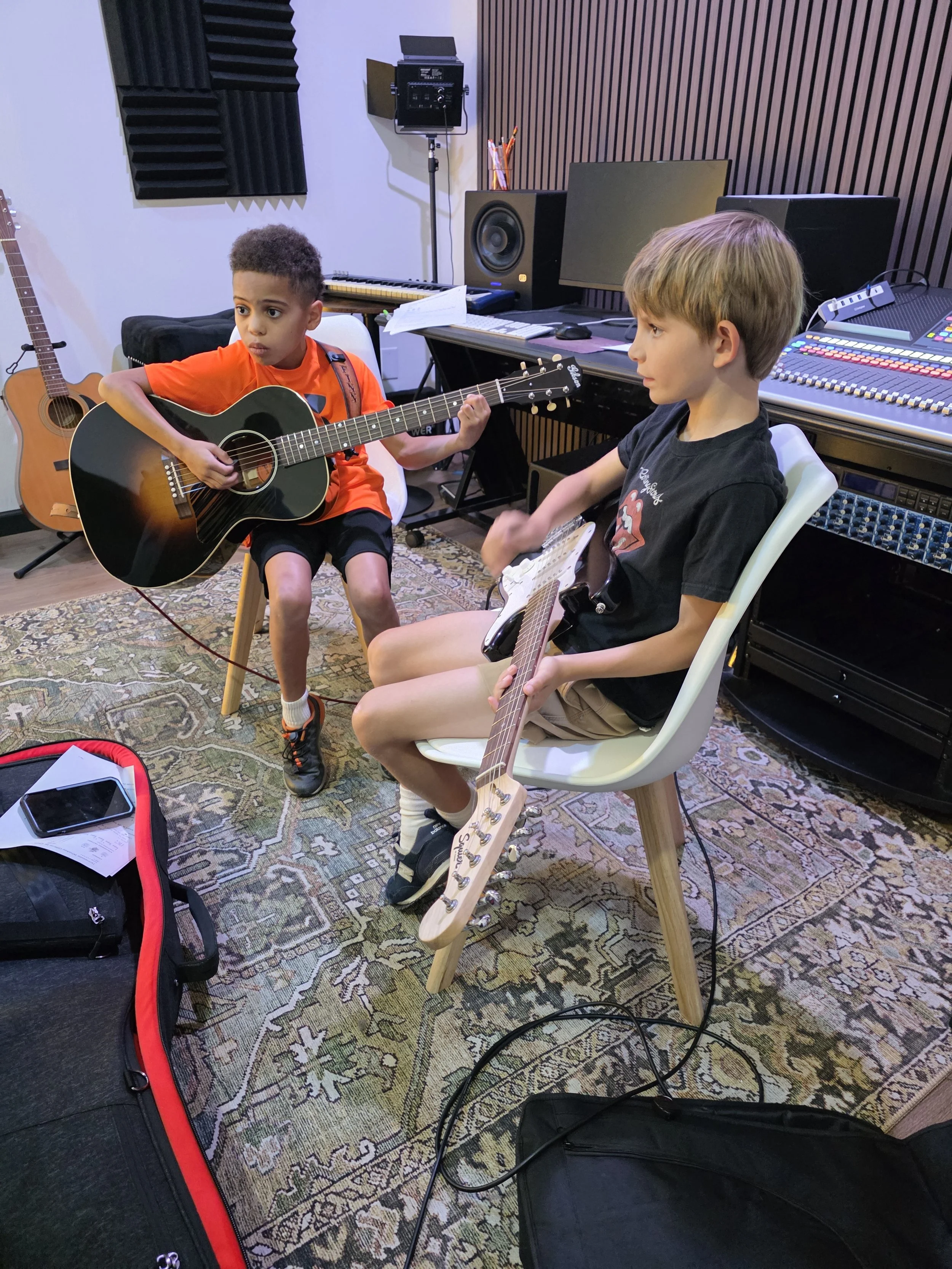 BRMS campers playing guitar in the studio