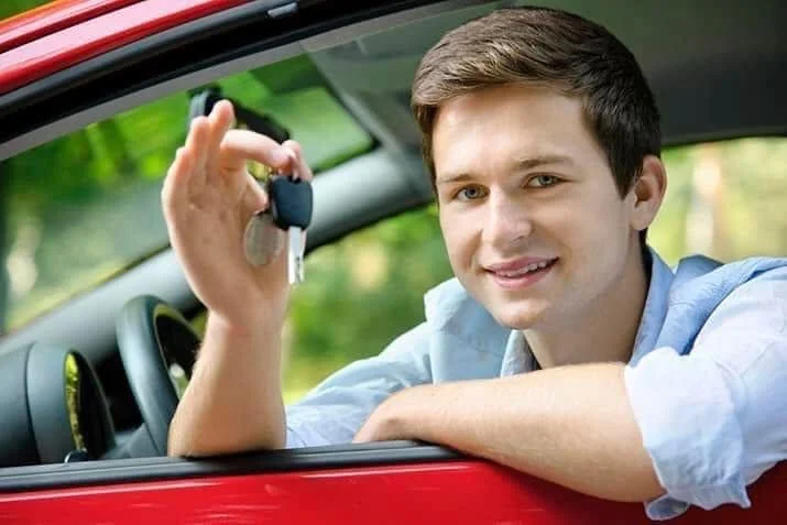 Young driver holding car keys
