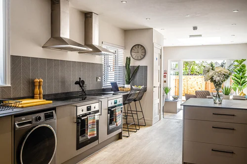 An open plan communal kitchen with a breakfast bar