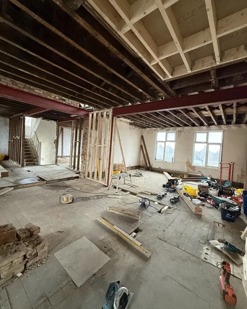 The Lofts at rip-out stage: exposed joists, stripped walls and a bare concrete floor