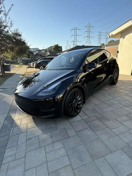 A modern white Tesla with a deep, glossy finish from a ceramic coating.