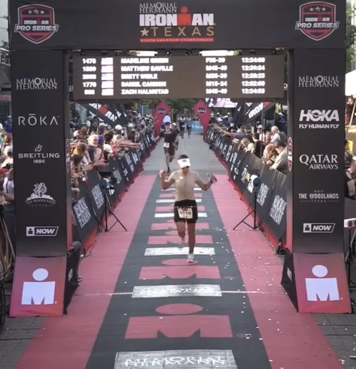 Athlete crossing the Ironman 70.3 finish line