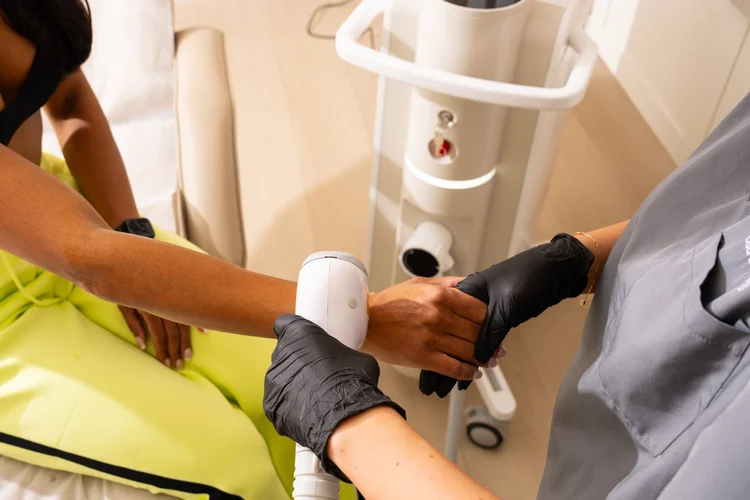 Danielle performing laser hair removal on a darker skin tone at Skyn Lab
