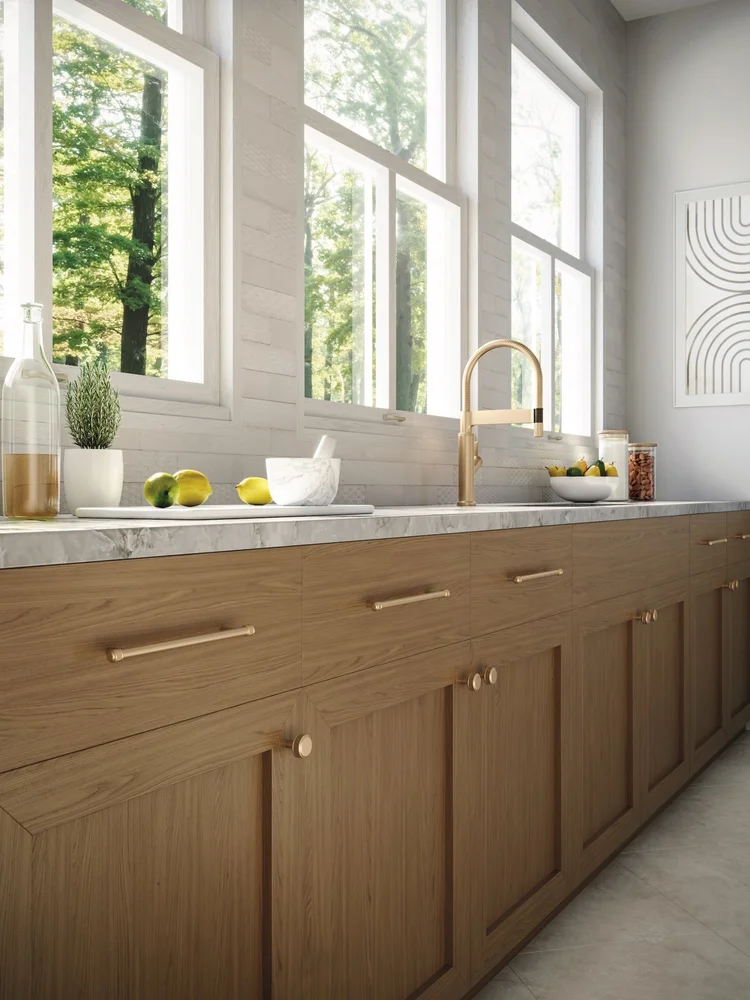 Top Knobs brass cabinet pulls and knobs on warm wood drawers