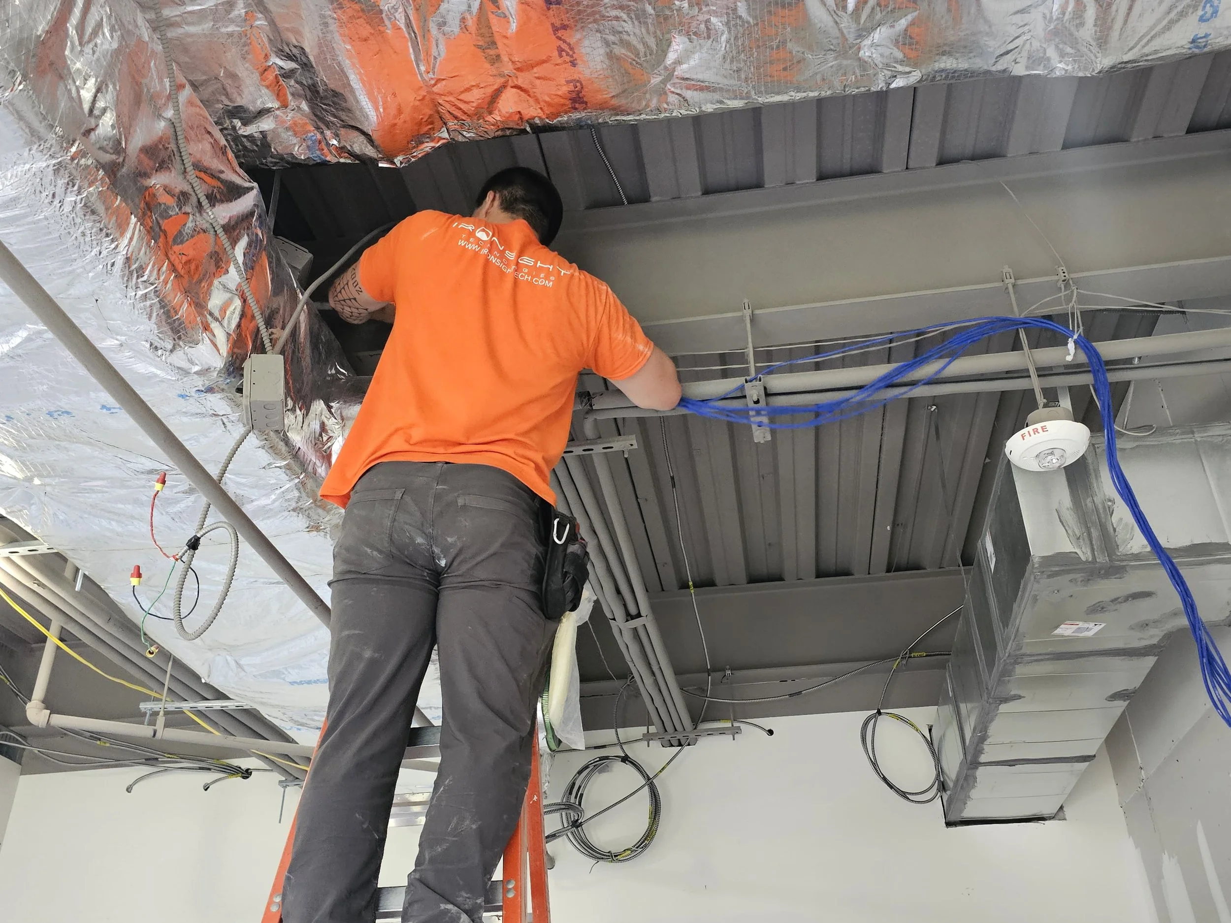 Before: Ironsight technician installing low-voltage cabling and infrastructure at the Westminster Maryland life sciences project